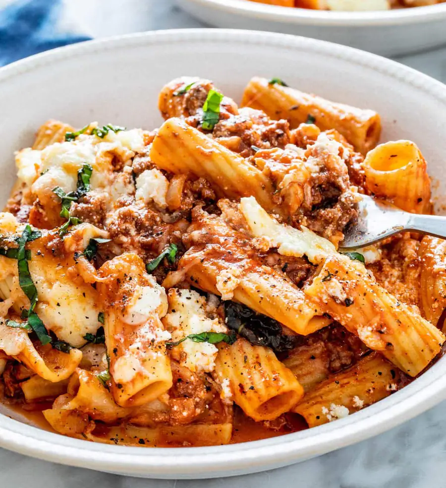 Baked rigatoni with meat sauce, ricotta and melted mozzarella