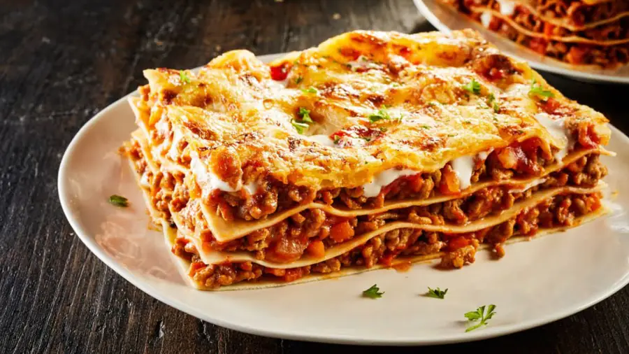 A square of baked lasagna on a white plate